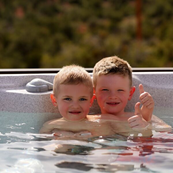 Two boys enjoying hot tub