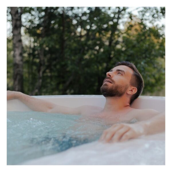 man relaxing in a hot tub