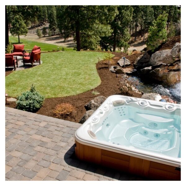 Backyard hot tub near lawn and seating area