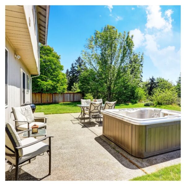 Patio hot tub with chairs and table nearby