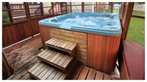 Wooden hot tub on enclosed porch.