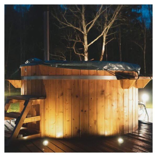 Wooden hot tub at night, dimly lit surroundings