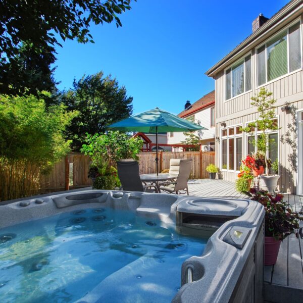 two story house with hot tub in the backyard 