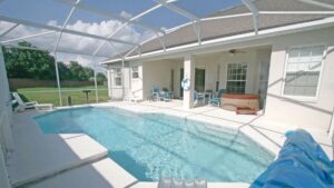 house with pool and hot tub covered with screened area